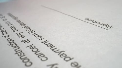 Businessman sign signature on document contract paper at office desk