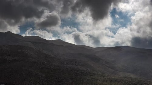 Dark Cloud Parts Movement in Treeless Mountainous Hills
