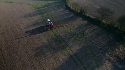 Tractor Spraying Fields on an Arable Farm with Glyphosate Herbicide
