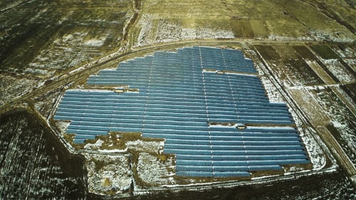 Aerial View of Solar Panel Farm in Rural Landscape