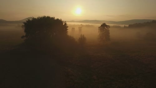 Sunrise Aerial Over Foggy Rural Landscape