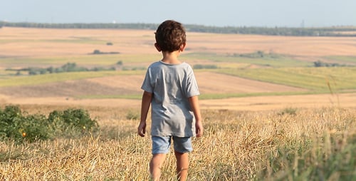 Child Walking in Garden