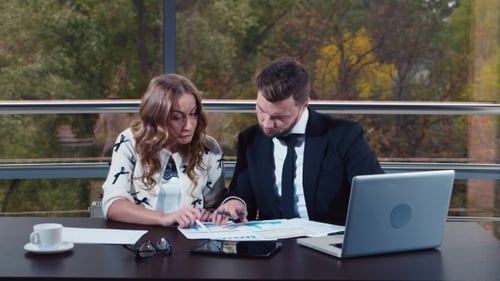 Stressed Business Team Reviewing Data in Office