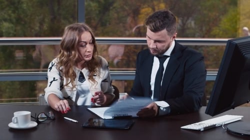 Young Woman Signs Documents In The Office