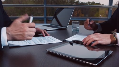Businessmen Working, Signing Documents at a Table