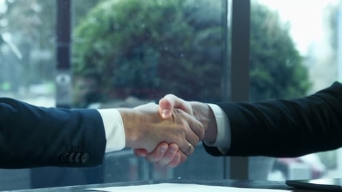 Businessmen Handshake and Discuss Deal in Office