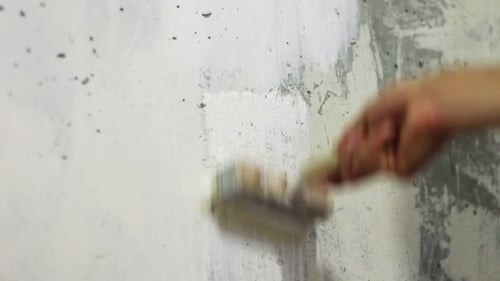 Paint The White Concrete Wall With a Brush.