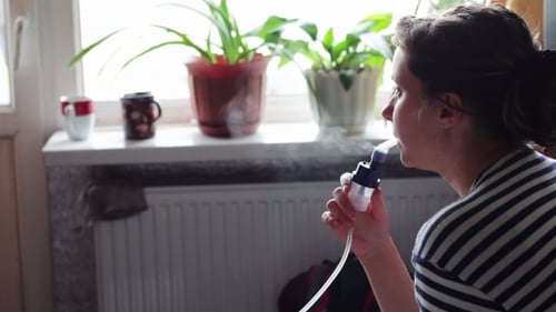 Woman Using Nebulizer for Respiratory Treatment