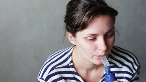 Woman Using Nebulizer for Respiratory Treatment