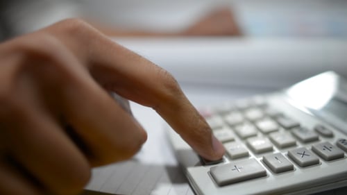 Fingers Using Calculator to Perform Calculations