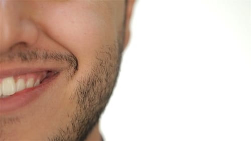 Man's Half Face Smiling Against White Backdrop