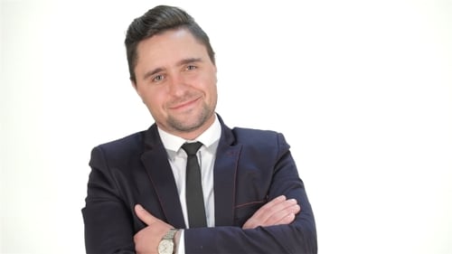 Man in Suit With Arms Crossed Smiling