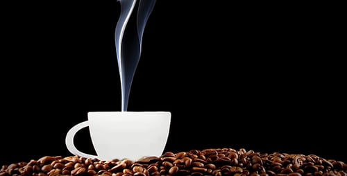 Steaming Coffee Cup on Coffee Beans