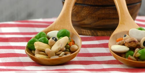 Spoons with Beans and Peas on Tablecloth