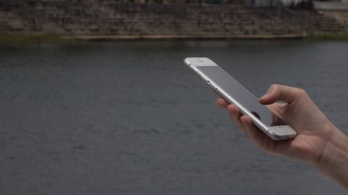 Hand Holding Smartphone Over Water, Typing, Browsing