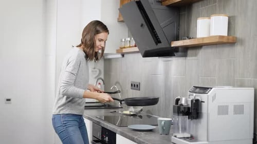 Woman Cooking Breakfast Food in Modern Kitchen