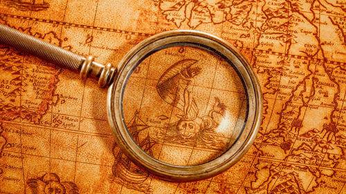Antique Map with Magnifying Glass on Display