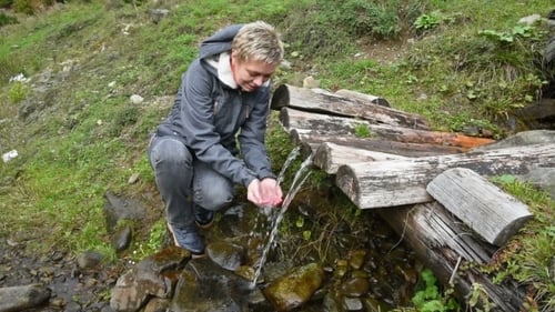 Girl Drinks Water From a Mountain Spring