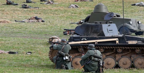 Soldiers with Tank in Battle Reenactment on Grassy Field