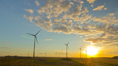 Windmills Generators At Sunset