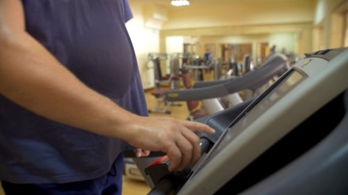 Man Using Treadmill in Gym for Fitness
