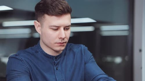 Manager Working at Laptop in Office