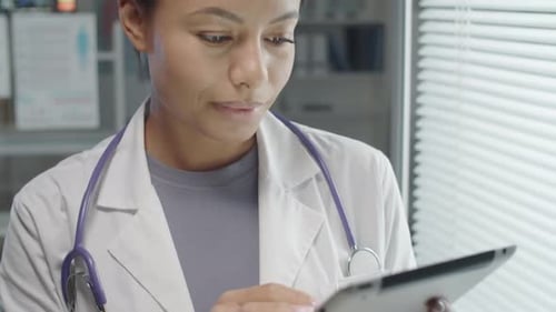 Doctor Working on Tablet in Hospital Environment
