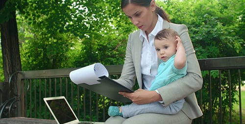 Woman Working in the Park with Infant