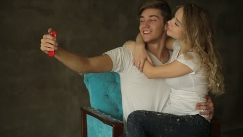 Young Couple Take Selfie In Studio