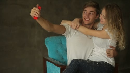 Young Couple Take Selfie In Studio