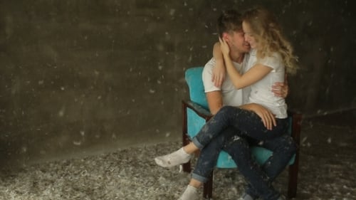 Beautiful Couple Sitting On a Chair In The Studio