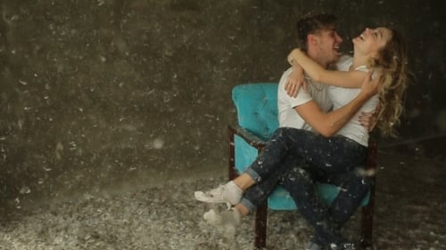 Beautiful Couple Sitting On a Chair In The Studio