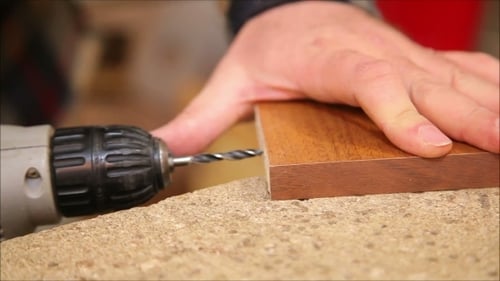 Man Using Electric Drill On Wood Close Up