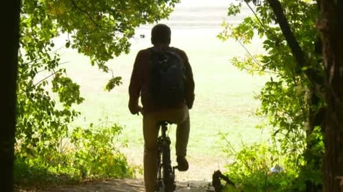 Man Rides Down On The Bicycle Frome The Hill To