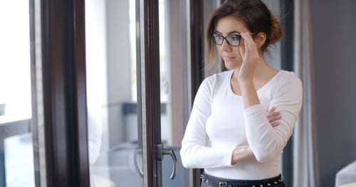 Attractive Young Woman Looking Out Window Thoughtfully