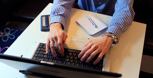 A Man Working On a Laptop And Use The Phone