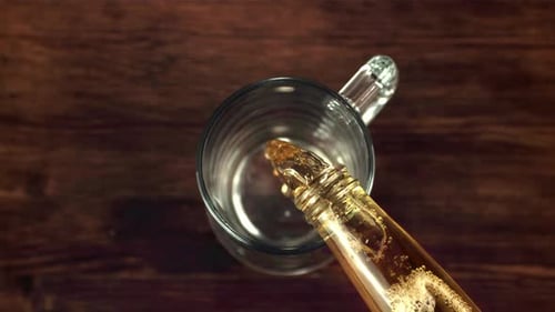 Beer Pouring into Mug From Bottle Close Up