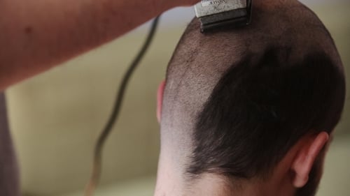 Close Up of Clippers Shaving the Back of Head
