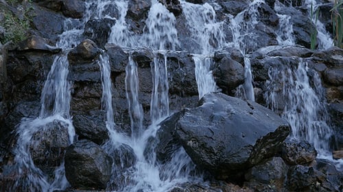 Waterfall Cascading Over Rocks in Natural Setting