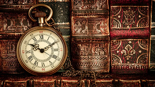 Antique Pocket Watch Leaning Against Old Books