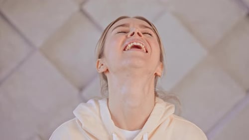 Joyful Young Blonde Female Laughs