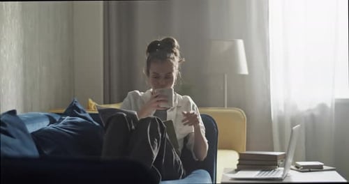 Young Woman Studying at Home on Couch
