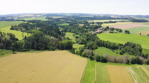 Aerial Drone Shot a Rural Area with Forests Fields and a Village