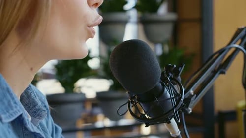 Woman Speaking Into Microphone For Podcast