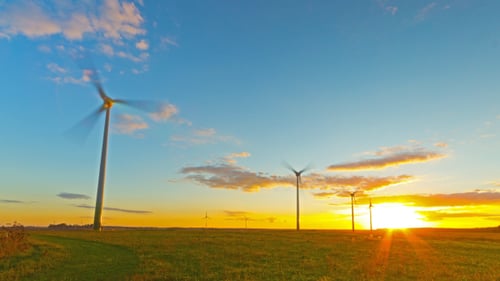 Windmills Generators At Sunset