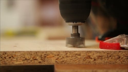 Drill Cutting Circular Hole in Wood Board