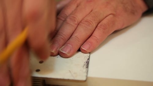 Worker Handles a Wooden Board