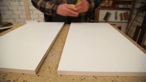 Worker Handles a Wooden Board