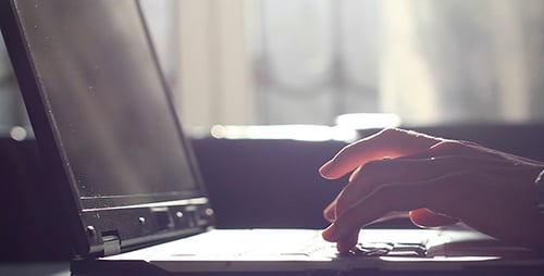 Person Typing on Laptop Computer in Home
