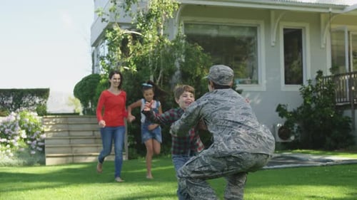 Soldier Returns Home to Family on Sunny Lawn
